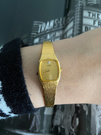 Vintage 1980s Ladies Seiko Gold Tone Watch with a Diamond Accent